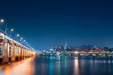Fototapeta na wymiar night and city scape travel and photography activity from banpo bridge is beautiful architecture and design during show fountain moving to people and traveler with reflection in river background