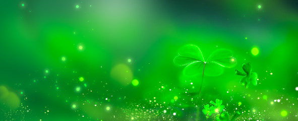 St. Patrick's Day green background decorated with shamrock leaves. Patrick Day pub party celebrating. Abstract Border art design, Magic nature backdrop. Widescreen clover art design with copy space