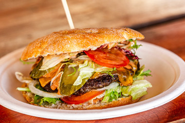 Sandwich hamburger with and mix of vegetables. Fast food. Delicious hamburger