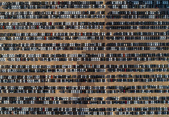 Top view of parking space with new cars lined up outside an automobile factory