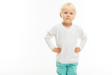 charming blond boy in a white t-shirt on a white background with copy space