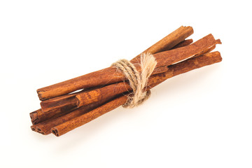 Cinnamon sticks heap isolated on white