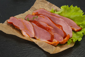 Sliced smoked duck breast served salad