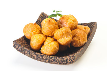 Sweet tasty profiteroles heap in the bowl