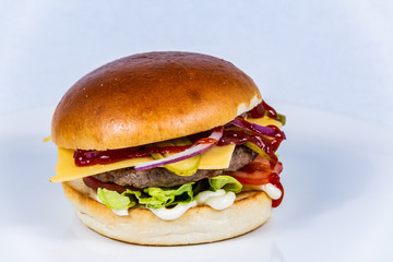 Sandwich hamburger with and mix of vegetables. Fast food. Delicious hamburger