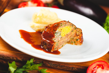 Zrazy cutlets with minced meat, rice and eggs served with mashed potatoes on white plate.
