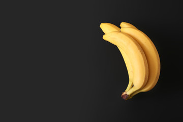 Yellow bananas on a dark background top view