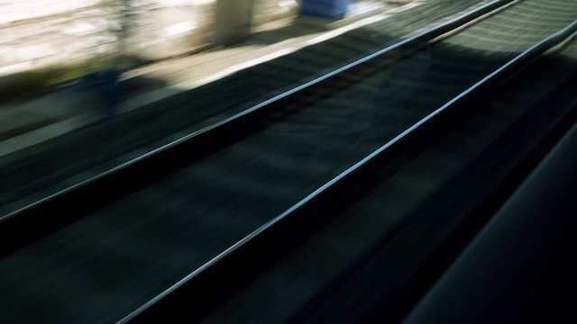 View on railroad track from the window of fast train. Bullet train rides on the railway track. 4K