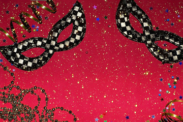 Festive masks with decor on a red background. Carnival celebration concept, Mardi Gras, Brazilian carnival, Venice Carnival, carnival costume, spring. Flat lay, top view, place for text © newrita