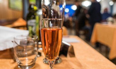 Glass of rose wine on the dining table in restaurant