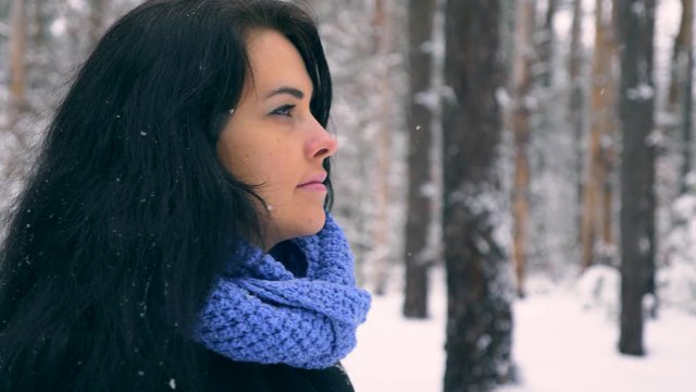 Serious Pretty Girl Walks Enjoying Nature In Winter Forest During Snowfall. Hiking Traveling on Winter Holidays. Frost Weather Snow Covered Trees In Wood. Slow motion 60 fps