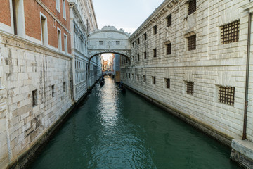 The Bridge of Sighs, famous bridge connects the Doge’s Palace to the prison, in Venice, Italy with gondolas