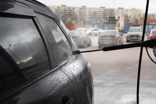 irty car in outdoor manual washing in winter cold time. wet works.
