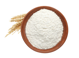 Organic flour and spikelets isolated on white, top view