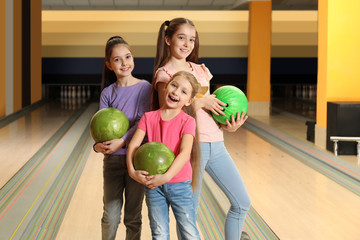 Fototapeta premium Happy girls with balls in bowling club