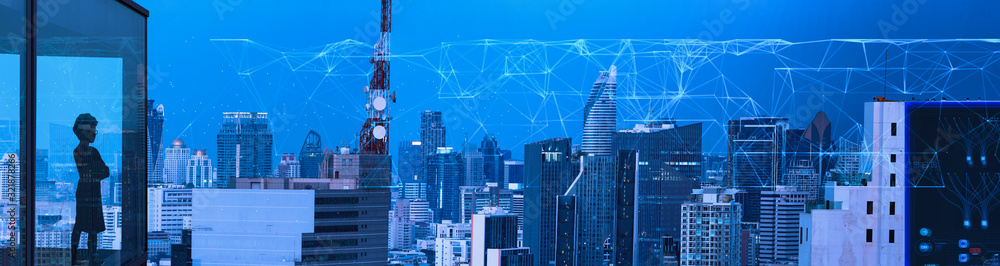 Poster businesswoman using mobbile phone with smart city and wireless communication network new technology 