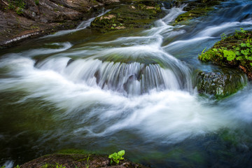 Fototapeta na wymiar Mountain stream with motion blur
