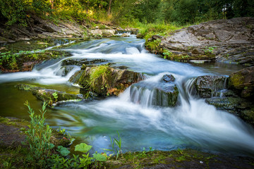 Fototapeta na wymiar Mountain stream rapids in motion blur