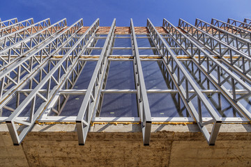 Extensive scaffolding providing platforms for work in progress on a new apartment block,Tall...