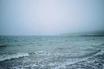 Seascape with city view in cold misty weather