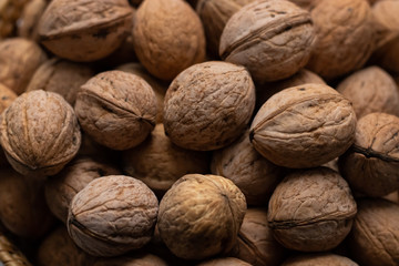 Walnuts close-up. A lot of nuts in a small basket. Background