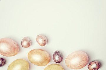 Top view of Easter pastel color eggs on white vintage background, flat lay