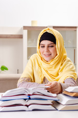 Female student in hijab preparing for exams