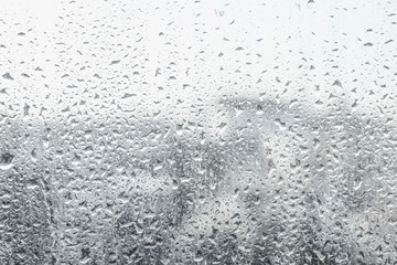 Blurred view of city from window on rainy day