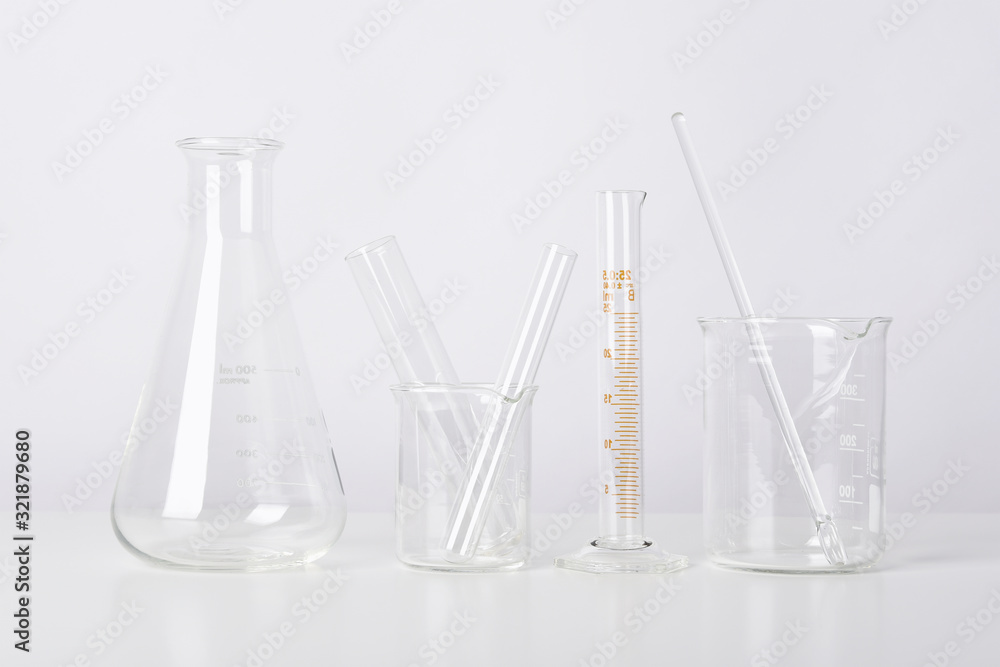 Wall mural group of scientific laboratory glassware with clear liquid solution, science research and developmen