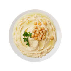 Flat lay view at hummus - spread made from cooked, mashed chickpeas topped with beans and green coriander leaves isolated on white background. Clipping path added