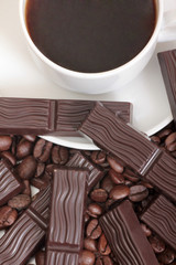 Coffee beans and cute chocolate. Isolated objects on a white background