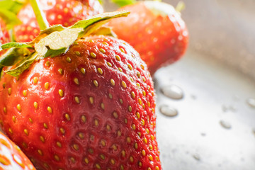  strawberry berries close up on a dark background