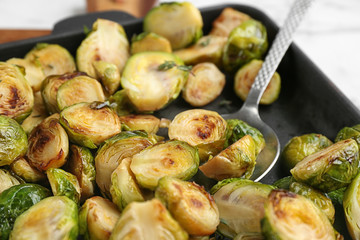 Delicious roasted brussels sprouts in baking dish, closeup