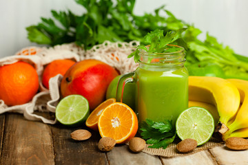Healthy eating, food and vegetarian diet concept - jar of fresh juice or smoothie with apple, celery. Antioxidant detox beverage. Clean organic ingerdients. Close up, wooden background, copy space