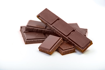 Dark chocolate bar pieces isolated