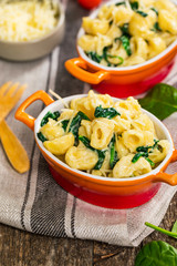 Parmesan Spinach Macaroni and Cheese on Wooden Background. Selective focus.