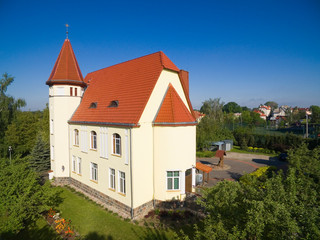 Fototapeta na wymiar Aerial view of Wegorzewo town, Poland (former Angerburg, East Prussia). Catholic Good Shepherd Church in the foreground