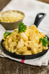 Macaroni and Cheese Old Fashioned Skillet on Wooden Background. Selective focus.