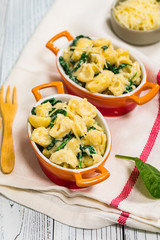Parmesan Spinach Macaroni and Cheese on Wooden Background. Selective focus.