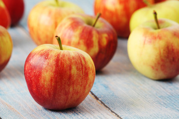 Several ripe red apples on the wooden table	