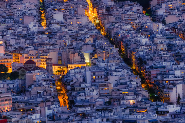 Amazing aerial night view of Athens cityscape. Traditional white houses at evening. Greece capital and famous ancient mediterranean town. 
