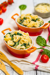 Parmesan Spinach Macaroni and Cheese on Wooden Background. Selective focus.