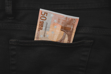 Fifty euro banknote money in pocket jeans pants background texture. 50 euro close up