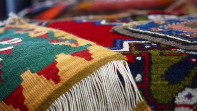 Pan right | Colorful rugs and carpets in old bazaar of Kayseri, Turkey | Silk Road