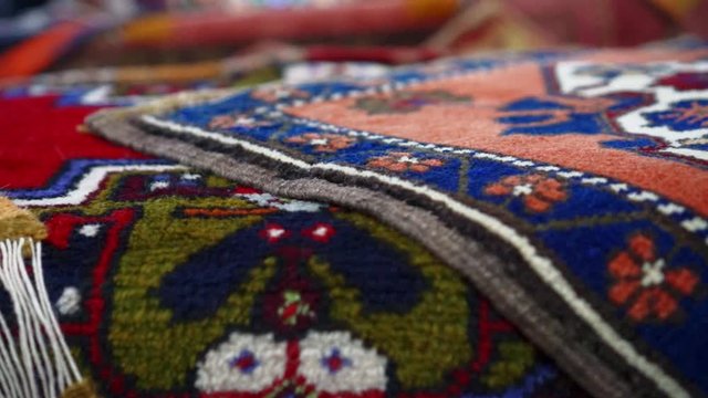 Pan left | Colorful rugs and carpets in old bazaar of Kayseri, Turkey | Silk Road