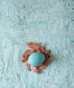 Easter. Turquoise egg on a turquoise background.