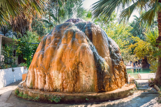 Pamukkalei, Turkey - September 17, 2019 : Orange travertine with mineral water with iron oxide. Turkey