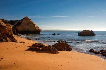 high cliffs and high tide on the shore of the Atlantic Ocean. Portugal. Algarve.