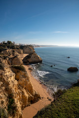 high cliffs and high tide on the shore of the Atlantic Ocean. Portugal. Algarve.