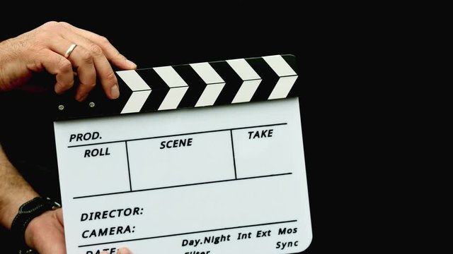 Footage of a person using a clapper board isolated on a black background